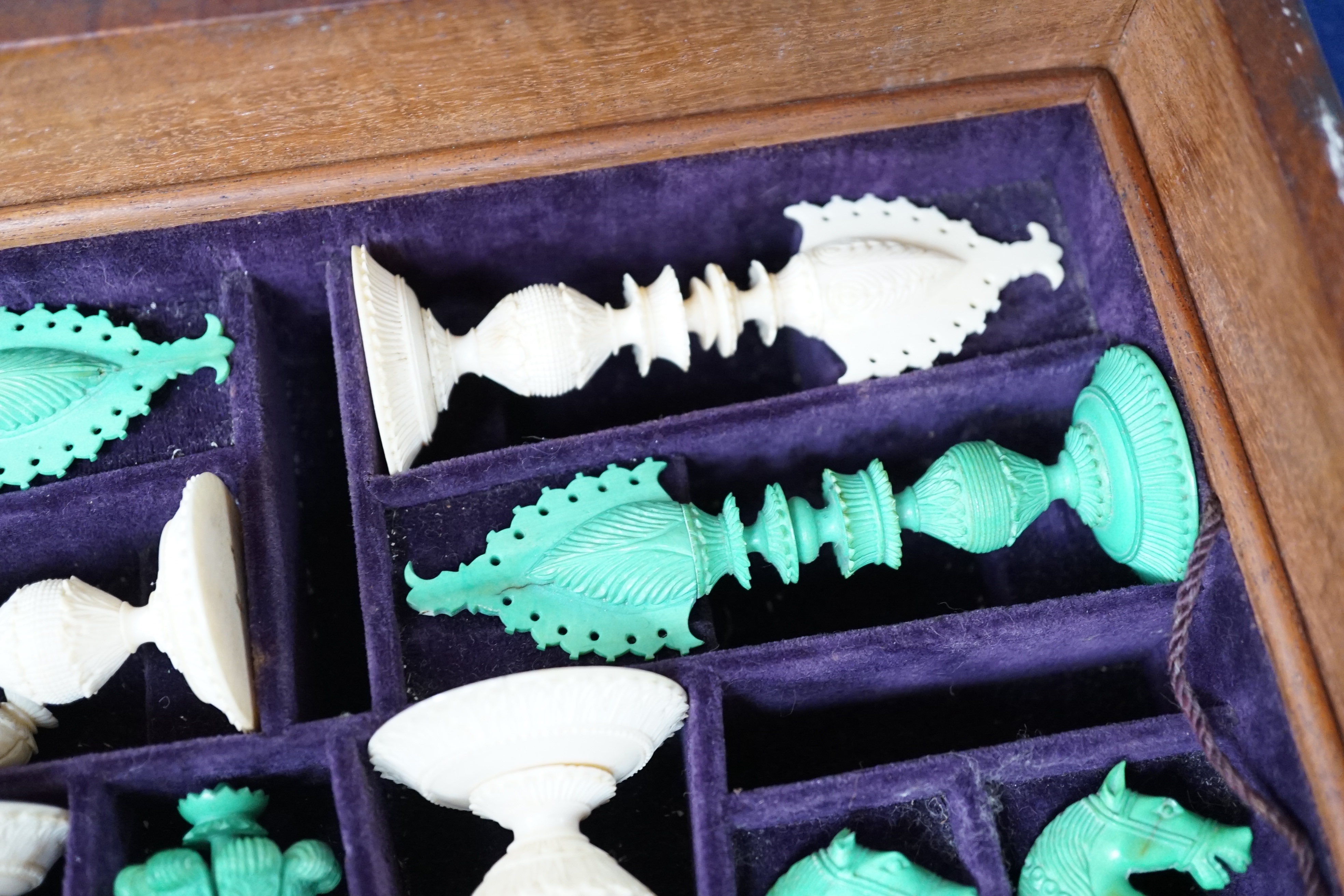 A boxed 19th century Burmese pattern ivory chess set, one pawn restored, king height 11cm